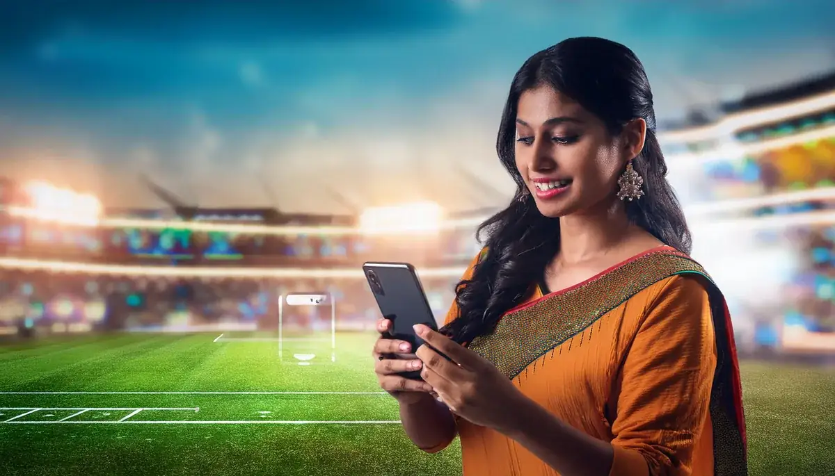 Player completing Laser247 login on a mobile phone at a cricket ground